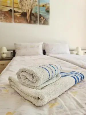 a pile of towels sitting on top of a bed at Maja Vujković Apartman 1 in Soko Banja