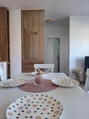 a table with two plates and a candle on it at Apartman Šara in Vrnjačka Banja