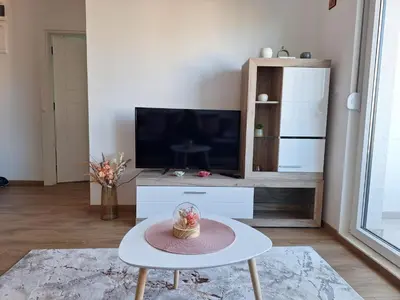 a living room with a tv and a table at Apartman Šara in Vrnjačka Banja