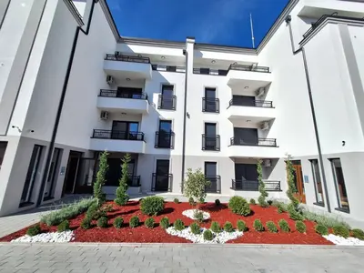 an apartment building with a garden in front of it at Apartman Šara in Vrnjačka Banja