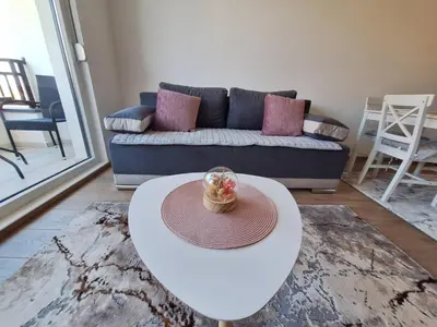 a living room with a white table and a couch at Apartman Šara in Vrnjačka Banja