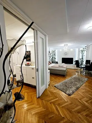 a living room with a couch and a table at Deluxe Jade Apartmens in Niš