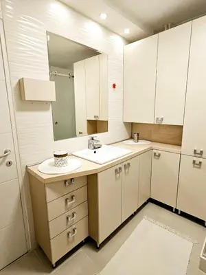 a bathroom with a sink and a mirror at Deluxe Jade Apartmens in Niš