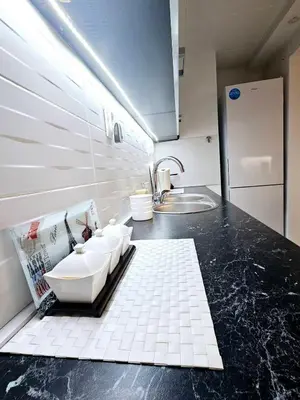 a kitchen with a sink and a counter top at Deluxe Jade Apartmens in Niš