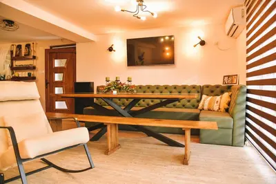 a living room with a couch and a table at Vila harmony in Trmčare