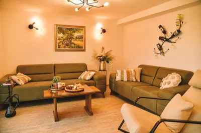 a living room with two couches and a table at Vila harmony in Trmčare