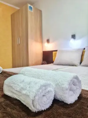 a bedroom with two beds with white towels on them at Vila Aleksandra 2 Studio 2 in Soko Banja