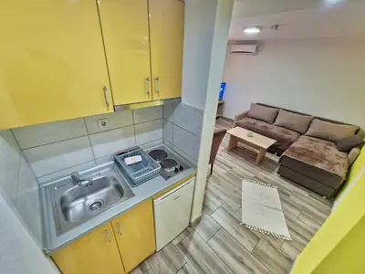 an overhead view of a small kitchen with a couch at Vila Aleksandra 2 Apartman 1 in Soko Banja