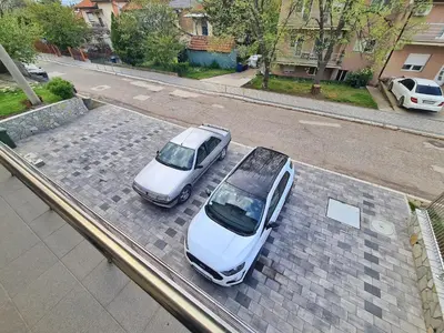 two cars parked next to each other on a street at Vila Aleksandra 2 Apartman 1 in Soko Banja