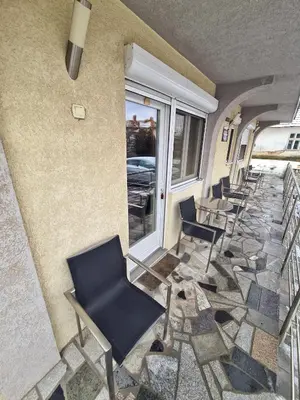 a row of chairs sitting next to a building at Vila Aleksandra 2 Apartman 1 in Soko Banja