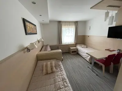 a hospital room with a bed and a table and a desk at Konaci Angella apartman 126 in Kopaonik