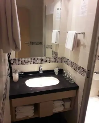 a bathroom with a sink and a mirror at Konaci Angella apartman 126 in Kopaonik