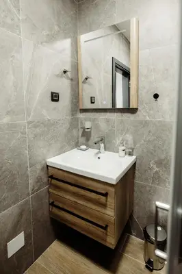 a bathroom with a sink and a mirror at Apartman Nina in Kopaonik