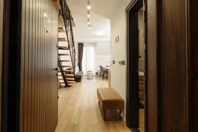 a hallway with stairs leading to a dining room at Apartman Nina in Kopaonik