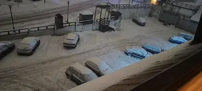 a group of cars parked in a parking lot in the snow at Apartmani Iva Kop Konaci in Kopaonik