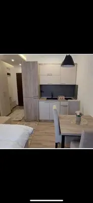 a kitchen and dining room with a table and chairs at Nikola Residence Hill in Raška