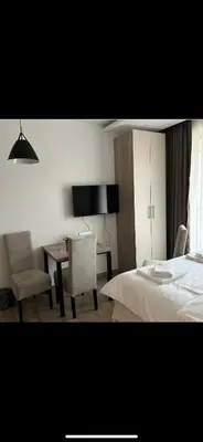 a bedroom with a bed and a table and chairs at Nikola Residence Hill in Raška