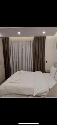 a bedroom with two white beds and a window at Nikola Residence Hill in Raška