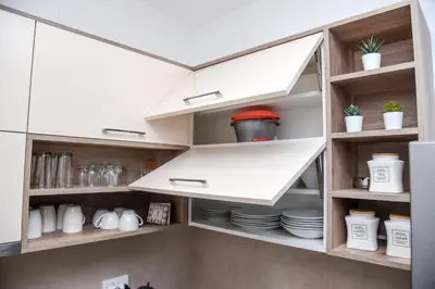 a kitchen with white cabinets and white dishes at Vila Montana, Kopaonik, Apartman Ivony in Kopaonik
