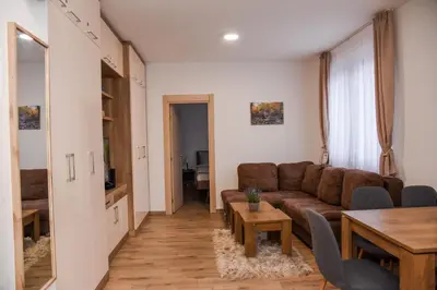 a living room with a couch and a table at Vila Montana, Kopaonik, Apartman Ivony in Kopaonik