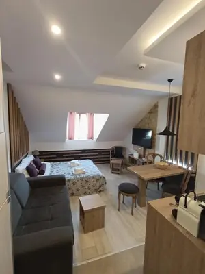 a living room with a couch and a table at Kopaonik - Milmari resort S66 in Kopaonik