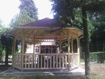 a large wooden gazebo in a park at Prenociste Gazela in Pirot