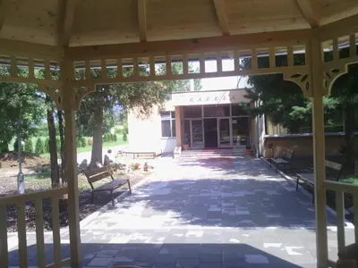 a pavilion with benches in front of a building at Prenociste Gazela in Pirot