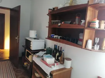 a kitchen with a counter with a microwave and a table at Vila Seoska idila in Izvor