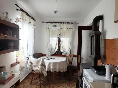 a kitchen with a table and a stove at Vila Seoska idila in Izvor