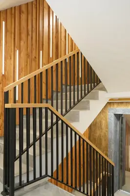 a staircase in a house with wooden walls at Vila Golija VM Apartment in Kopaonik