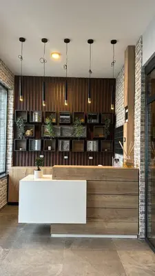 a lobby with a white reception desk in a building at Vila Golija VM Apartment in Kopaonik