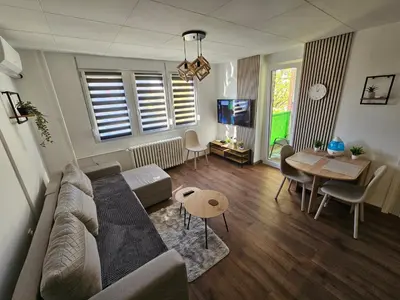 a living room with a couch and a table at Modern Apartment S22 in Niš