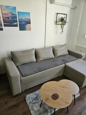 a living room with a couch and a table at Modern Apartment S22 in Niš