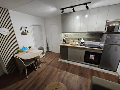 a kitchen with a table and a dining room at Modern Apartment S22 in Niš