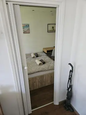 a bedroom with a bed and a mirror at Modern Apartment S22 in Niš