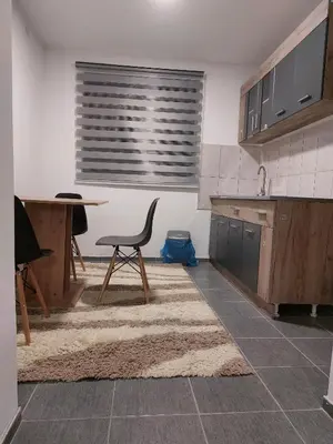 a kitchen with a table and a chair in it at R Apartments in Paraćin