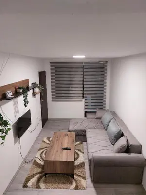 a living room with a couch and a coffee table at R Apartments in Paraćin