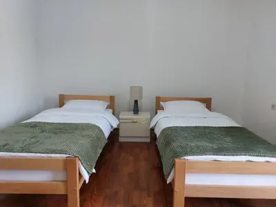 two beds sitting next to each other in a room at R Apartments in Paraćin