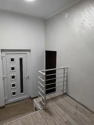an empty room with a door and a wooden floor at R Apartments in Paraćin