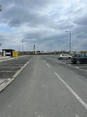 an empty parking lot with cars parked in it at Smart Apartmani in Kruševac