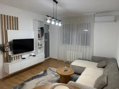 a living room with a couch and a tv at Smart Apartmani in Kruševac