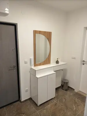 a bathroom with a sink and a mirror on the wall at Smart Apartmani in Kruševac