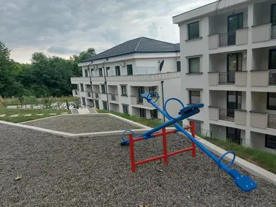 a playground in front of a apartment building at Apartman Nina VB in Vrnjačka Banja