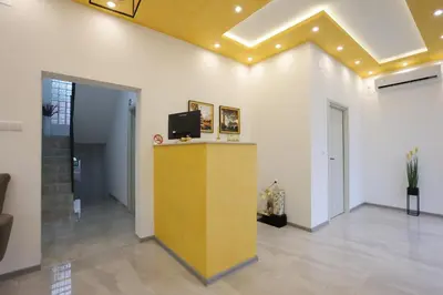 a lobby with a yellow counter with a tv on it at Ivan's guesthouse in Paraćin