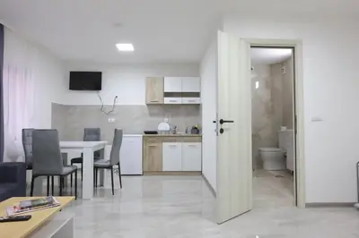 a kitchen and dining room with a table and chairs at Ivan's guesthouse in Paraćin
