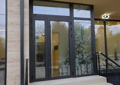 a glass door of a building with a sign on it at Ivan's guesthouse in Paraćin