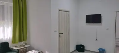 a room with a door and a green curtain at Ivan's guesthouse in Paraćin