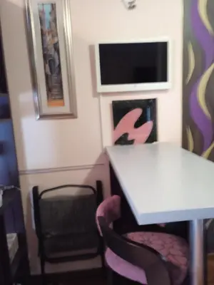 a dining room with a table and two chairs at apartman Studenička in Vrnjačka Banja