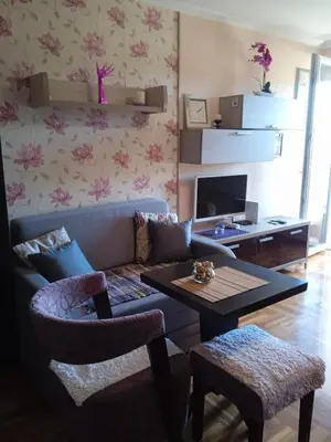 a living room with a couch and a table at apartman Studenička in Vrnjačka Banja