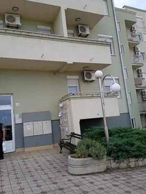 a building with a bench in front of it at apartman Studenička in Vrnjačka Banja